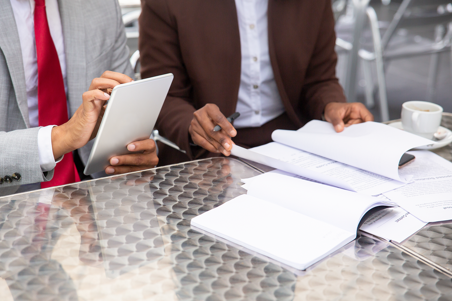 cropped-shot-two-businesspeople-working-with-documents